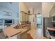 Open concept kitchen features stainless appliances, light green cabinetry, and a breakfast bar at 3017 Minuteman Ln, Brandon, FL 33511