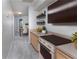 Modern kitchen with stainless steel oven, light wood cabinets and decorative shelving for a stylish cooking experience at 3017 Minuteman Ln, Brandon, FL 33511