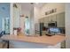Kitchen features green cabinets, stainless steel appliances, and a breakfast bar with seating at 3017 Minuteman Ln, Brandon, FL 33511