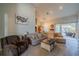 Cozy living room with a high ceiling, comfortable seating, and a view of the pool area through sliding glass doors at 3017 Minuteman Ln, Brandon, FL 33511