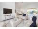 Open-concept living room with a view of the dining area and pool through sliding glass doors at 3017 Minuteman Ln, Brandon, FL 33511