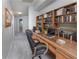 Spacious home office with an abundance of shelving and built-in desk for maximum productivity at 3017 Minuteman Ln, Brandon, FL 33511