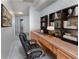 Spacious home office with a large desk, comfortable executive chair, and ample shelving for books and decor at 3017 Minuteman Ln, Brandon, FL 33511