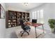 Office space featuring a large bookcase, modern desk, leather chair, natural light and a decorative plant at 3017 Minuteman Ln, Brandon, FL 33511