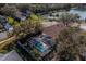 Aerial view of screened pool area in backyard with water view in distance at 3017 Minuteman Ln, Brandon, FL 33511
