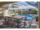 Screened lanai features a dining table overlooking the large private pool at 3017 Minuteman Ln, Brandon, FL 33511