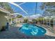 Backyard featuring a private screened pool and stone patio area at 3017 Minuteman Ln, Brandon, FL 33511