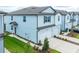 Light blue two-story home featuring a white garage door and a well-maintained lawn at 31381 Amberview Bend, Wesley Chapel, FL 33545