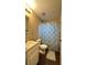 Practical bathroom with a vanity sink, toilet, and shower with a patterned curtain at 3211 E 23Rd Ave, Tampa, FL 33605