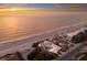 Majestic aerial of beachfront home with scenic views of ocean and beautifully maintained landscaping at 3341 Gulf Of Mexico Dr, Longboat Key, FL 34228