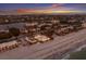 Wide aerial view of luxury beachfront community with a mix of homes, beach access and stunning ocean views at 3341 Gulf Of Mexico Dr, Longboat Key, FL 34228
