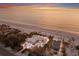 Expansive aerial view of beachfront home and lush landscaping near a beautiful beach and ocean at 3341 Gulf Of Mexico Dr, Longboat Key, FL 34228