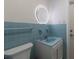 Bathroom with a ring light mirror, blue tiled walls, updated fixtures and a toilet at 3341 Gulf Of Mexico Dr, Longboat Key, FL 34228