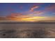 Scenic beach view captures golden sunset reflecting on ocean's tranquil surface at 3341 Gulf Of Mexico Dr, Longboat Key, FL 34228