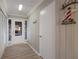 Well-lit hallway with door and view to the outside at 3341 Gulf Of Mexico Dr, Longboat Key, FL 34228