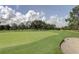 Lush green golf course highlighting a sand trap and manicured green at 3347 E Dorchester Dr, Palm Harbor, FL 34684