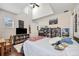Well-lit bedroom with ceiling fan and hardwood floors, featuring a bed, desk, and posters at 4301 W San Luis St, Tampa, FL 33629