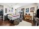 Bright bedroom with a ceiling fan, featuring hardwood floors, a bed, and a variety of art at 4301 W San Luis St, Tampa, FL 33629