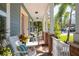Cozy front porch with brick flooring, white railing, and comfortable seating, perfect for relaxing at 4301 W San Luis St, Tampa, FL 33629