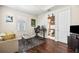 Open-concept living room with office, dark hard wood floors, sofa, coffee table and TV at 4301 W San Luis St, Tampa, FL 33629