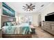 Comfortable primary suite with a ceiling fan, a bench, stylish decor, and generous natural light at 4301 W San Luis St, Tampa, FL 33629