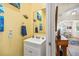 Well-lit powder room featuring elegant mirror, bright yellow paint, and stylish fixtures at 4301 W San Luis St, Tampa, FL 33629