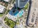 Aerial view of two shimmering pools, mature landscaping, and covered seating nestled between two luxury residential towers at 449 S 12Th St # 2702, Tampa, FL 33602