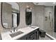 This luxurious bathroom features double sinks, a glass shower enclosure, and stylish tile work at 449 S 12Th St # 2702, Tampa, FL 33602