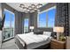 Bright bedroom showcasing skyline views and stylish black and white patterned curtains at 449 S 12Th St # 2702, Tampa, FL 33602