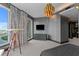A bedroom featuring a large picture window with views of the bay, a telescope, and modern decor at 449 S 12Th St # 2702, Tampa, FL 33602