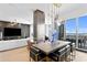 Open dining area with a large table, modern chandelier, and views of the living room and city at 449 S 12Th St # 2702, Tampa, FL 33602