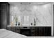 Modern kitchen features a sleek design with marble backsplash and countertops, and black cabinetry at 449 S 12Th St # 2702, Tampa, FL 33602