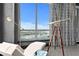 Bright living room featuring a white chaise lounge, a telescope, and large picture windows overlooking the city and the bay at 449 S 12Th St # 2702, Tampa, FL 33602