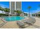 Resort-style pool with waterfall feature, plenty of lounge chairs, and lush tropical landscaping at 449 S 12Th St # 2702, Tampa, FL 33602