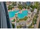 An aerial view of a luxurious pool area with palm trees and plenty of lounge chairs for relaxing at 449 S 12Th St # 2702, Tampa, FL 33602