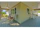 Expansive outdoor back porch with ceiling fans, ideal for relaxing or entertaining guests at 470 Hibiscus N Ln, Dunedin, FL 34698