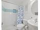 Clean bathroom featuring a walk-in shower, white tiles and vanity at 470 Hibiscus N Ln, Dunedin, FL 34698