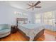 Calm bedroom with wood floors, neutral walls, a ceiling fan, and lots of natural light at 470 Hibiscus N Ln, Dunedin, FL 34698