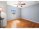 Bright, empty bedroom with hardwood floors, fan and natural light at 470 Hibiscus N Ln, Dunedin, FL 34698