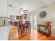 Open dining area featuring hardwood floors, stylish furnishings, and a view of the kitchen and doors to the outside at 470 Hibiscus N Ln, Dunedin, FL 34698