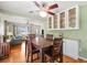 Open-concept dining area with hardwood floors, stylish table set, and plenty of natural light at 470 Hibiscus N Ln, Dunedin, FL 34698