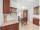 Cozy dining area with a view of a laundry area and access to the backyard at 470 Hibiscus N Ln, Dunedin, FL 34698