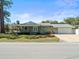 Classic home with a covered porch and a spacious garage, set on a well-manicured lawn at 470 Hibiscus N Ln, Dunedin, FL 34698