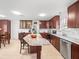 Bright kitchen features granite countertops, stainless steel appliances, and ample cabinet space with eat in kitchen table at 470 Hibiscus N Ln, Dunedin, FL 34698