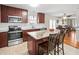 Well-equipped kitchen boasts stainless appliances, granite countertops, and a breakfast bar with seating at 470 Hibiscus N Ln, Dunedin, FL 34698