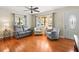 Inviting living room with hardwood floors, lots of windows, and seating for relaxing and enjoying the view at 470 Hibiscus N Ln, Dunedin, FL 34698