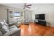 Cozy living room with hardwood floors, natural light, and comfortable seating arrangement at 470 Hibiscus N Ln, Dunedin, FL 34698