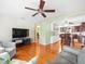 Spacious living room flowing into dining area with hardwood floors and modern decor at 470 Hibiscus N Ln, Dunedin, FL 34698