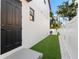 Side yard featuring artificial turf, perfect for low-maintenance outdoor living at 5040 Rena N St, St Petersburg, FL 33709