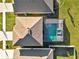 Aerial view of a house with a screened-in pool and spa at 5456 Logan Cave Ave, Wimauma, FL 33598